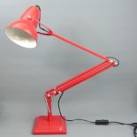 A red metal angle-poise table or desk lamp. 56 cm high as photo. UK Postage £25