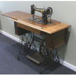 Singer treadle sewing machine on a wrought iron stand. Collection only.