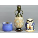 A Royal Doulton twin handled art pottery vase, tobacco jar and a Staffordshire pottery Toby jug.