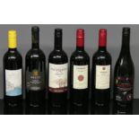 Six bottles of assorted red wine from Europe and South Africa.