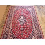 Rich red ground Persian Kashan carpet floral medallion design. 295 x 195 cm.