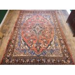 Full pile washed red ground Persian Sarouk floral design carpet. 320 x 210 cm.