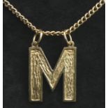 Vintage 9 carat gold 'M' pendant and 52 cm chain, London 1976. 10.4 grams. M 25 mm in length. UK