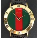 Gents Gucci gold tone 3000.2M boxed wristwatch. 23 cm long 3.5 cm wide (inc. button). UK Postage £