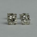 A pair of 18ct white gold diamond earrings (approx. 1ct in total). 1.3 grams. 5.4 mm diameter. UK