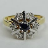 18 carat gold Sapphire and Diamond cluster ring, London 1977. Size P, top 12.2 mm. 5 grams. UK