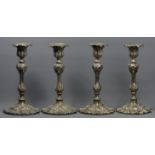 A set of four Victorian silver plated candlesticks of ornate form. 25.5 cm high. UK Postage £20.