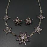 Sterling silver amethyst and marcasite flower design necklace and earrings. 15.8 grams. 43.5 cm