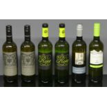 Six Italian and Spanish bottles of white wine.