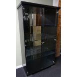 A large display cabinet enclosing three glass shelves. 179 x 100 x 49 cm.