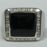 9 carat white gold onyx and diamond ring, 13.2 grams. Size Q 1/2, 16 mm top, 8 mm band.