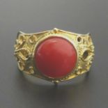 18 carat gold coral cabochon set fancy mount signet ring, 5.1 grams. Size P, band 5 mm, top 14.5 mm.