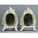 A pair of Paris porcelain figural floral encrusted, easel back mirrors, circa 1880. 21 cm high. UK