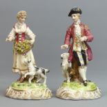 A pair of German porcelain figures modelled as a young couple with their dogs. 19.5 cm high. UK