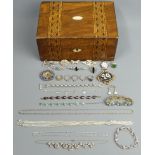 A Victorian walnut inlaid jewellery box and contents, including silver chains and brooches. UK