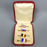 A cased set of four Sterling silver and enamel flag design bar brooches. Birmingham 1910. 40 mm