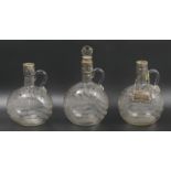 Three Victorian silver plate and engraved glass spirit decanters. 23 cm tallest. UK Postage £20.