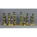 Four pairs of Victorian brass candlesticks, a single one and a brass bell. 26 cm tallest. UK Postage