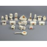 Eighteen pieces of novelty crested china, including an armoured car and a yacht. Tallest 12 cm.