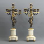 A 19th century pair of French bronze and ormolu figural four branch candelabrum with detachable