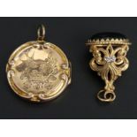 9 carat gold locket Chester 1911 and a 9 carat gold onyx set fob. Locket 27 mm in diameter. 10.3