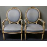 A pair of gilt wood and painted open arm salon chairs. 64 w x 98 h cm. Collection only.