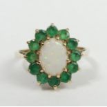 A 9 carat gold emerald and opal ring, Birmingham 1987, 2 grams. Size J 1/2, 14 mm top. UK Postage £