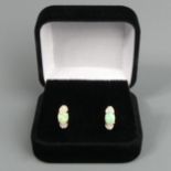 A pair of 9 carat gold opal and diamond earrings, 1.4 grams. 11.4 x 5.3 mm. UK Postage £12.