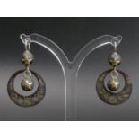 A Victorian pair of tortoiseshell earrings inlaid with yellow and white metal on silver wires. 34 mm