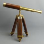 A boxed mahogany and brass telescope on a tripod extendable stand. 23 cm closed 44 cm open. UK