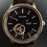 Bulova gents rose gold tone automatic watch with visible escapement 97A109 on a brown leather