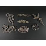 Seven silver and marcasite brooches including a dragon example (6 cm wide). UK Postage £12.