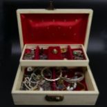 A box of costume jewellery, including a silver and garnet bracelet, silver bangles and chains. UK