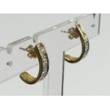 A pair of 9 carat gold diamond set earrings, 2.8 grams. 17 x 4.1 mm. UK Postage £12.