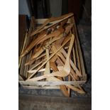 A QUANTITY OF WOODEN COAT HANGERS