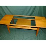 A RETRO G-PLAN TEAK AND GLASS TWO TIER COFFEE TABLE H-43 L-137 CM