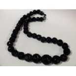 A CARVED WHITBY JET BEADED NECKLACE