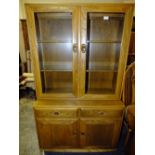 AN ERCOL WINSOR GLAZED BOOKCASE WITH TWO DRAWERS AND CUPBOARDS BELOW H-160 W-91 CM