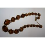 A VINTAGE TIGERS EYE STYLE AGATE NECKLACE, in a gilt mount