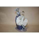 A LARGE NAO 'A DREAM COME TRUE' FIGURE OF A SEATED BALLERINA WITH A JESTER BEHIND