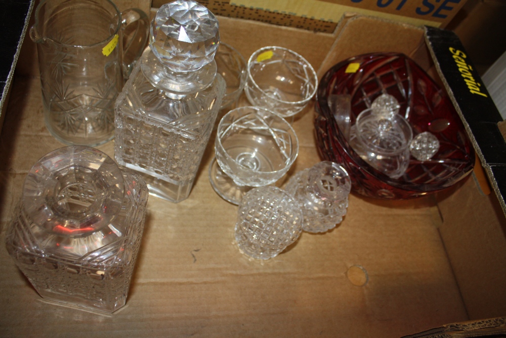 A BOX OF CUT GLASS TO INCLUDE DECANTERS, RED CUT GLASS BOWL
