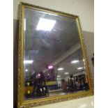 A LARGE MODERN GILT FRAMED WALL MIRROR 130 X 99 CM