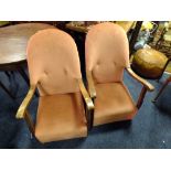 A PAIR OF VINTAGE OAK FRAMED UPHOLSTERED ARMCHAIRS