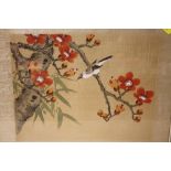 A FRAMED AND GLAZED ORIENTAL OIL ON SILK OF A BIRD ON A BRANCH