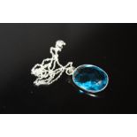 A STERLING SILVER AND BLUE TOPAZ PENDANT ON CHAIN