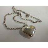 A LARGE SILVER HEART SHAPED LOCKET ON SILVER CHAIN, APPROX TOTAL WEIGHT 25.8G