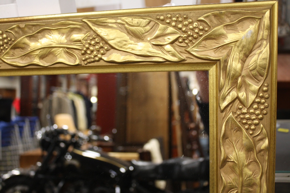 A LARGE GILT FRAME WALL MIRROR WITH RELIEF DETAIL TO THE FRAME, OVERALL SIZE INC FRAME 98.5CM X - Image 2 of 2