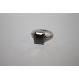A STERLING SILVER AND BLACK DIAMOND STYLE DRESS RING