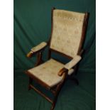 AN EARLY 20TH CENTURY MAHOGANY FOLDING ARMCHAIR