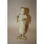 A JAPANESE CARVED IVORY OKIMONO, depicting an artist / scholar, the right hand with a missing